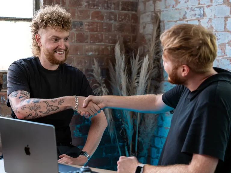 Dan Dennis shaking the hand of one of his video and marketing clients.