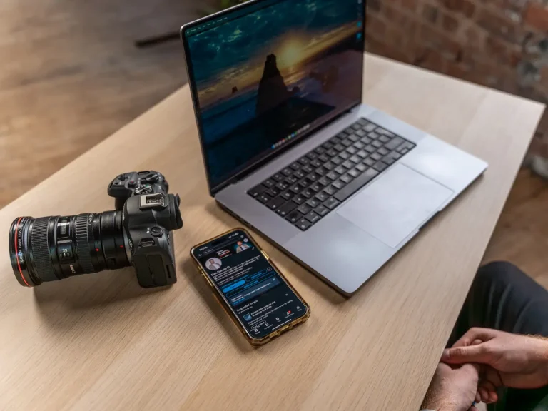 A video camera, a laptop and a mobile phone with Dan Dennis' Linkedin account open on a table.